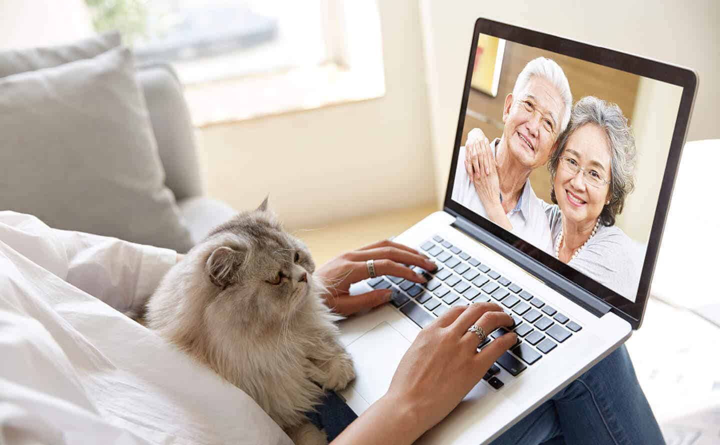 Person video chatting with senior parents