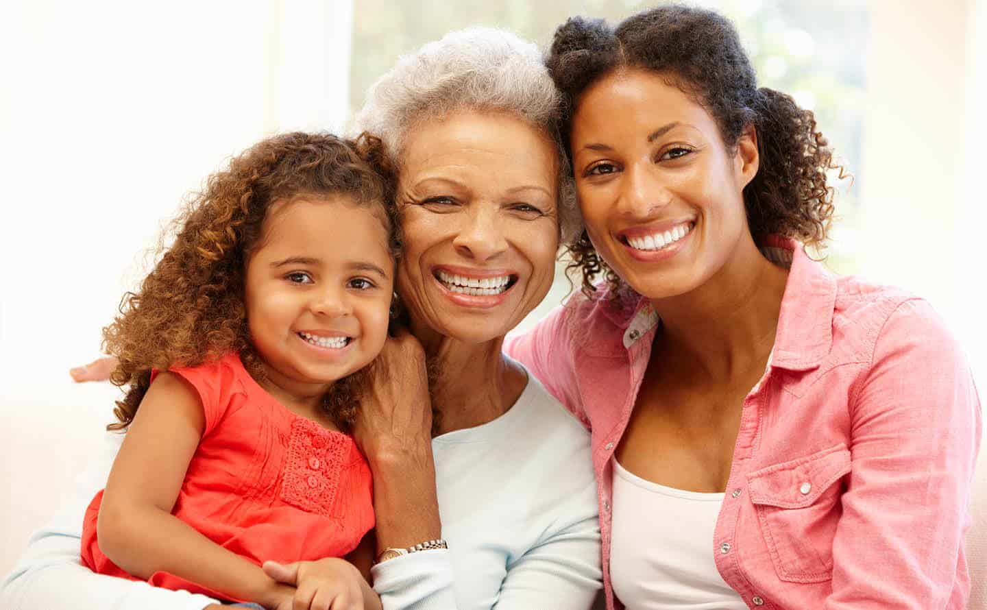 Multi generational women, grandmother, mother, child, smiling.