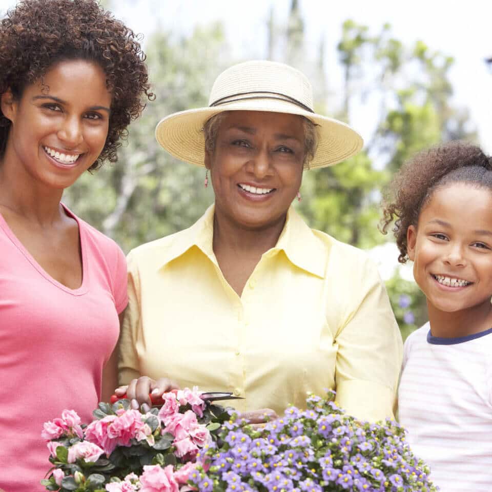 Grandmother, daughter and grand daughter holding flowers