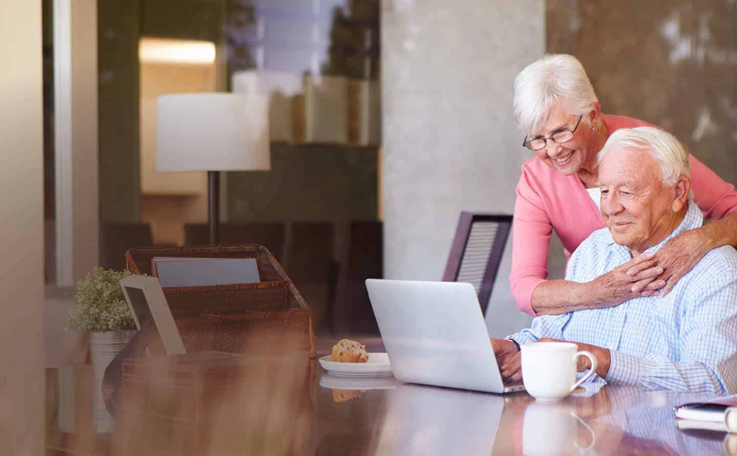 Senior couple enjoying breakfast while educating themselves online