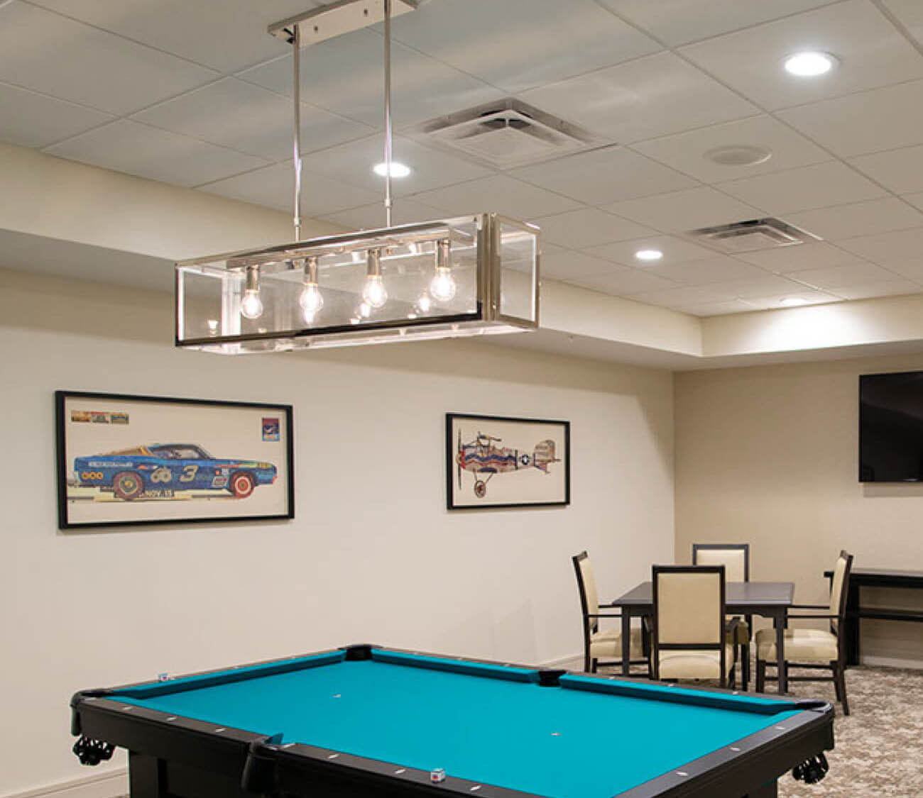 Game room at Highpoint at Cape Coral including pool table and card table.