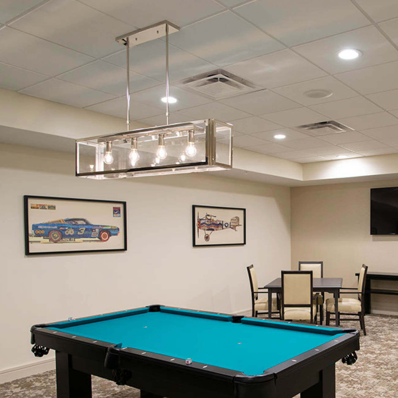 Game room at Highpoint at Cape Coral including pool table and card table.